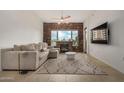 Living room featuring stylish decor, a modern ceiling fan, and a brick fireplace creating a warm ambiance at 2302 N Central Ave # 206, Phoenix, AZ 85004