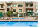 Beautiful community pool with well-maintained landscaping and several lounge chairs for relaxing poolside at 2302 N Central Ave # 206, Phoenix, AZ 85004