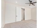 Bright bedroom with neutral walls, carpet flooring, a modern ceiling fan, and a closet at 24183 N 196Th Ln, Surprise, AZ 85387