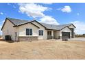 A bright and inviting home with large windows, a gray roof, and a xeriscaped front yard at 24183 N 196Th Ln, Surprise, AZ 85387