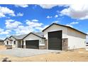 View of a modern home with a neutral palette, gray roof, and three-car garage at 24183 N 196Th Ln, Surprise, AZ 85387