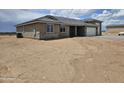 Side view of house with gray tile roof, stone accents and spacious two-car garage at 24183 N 196Th Ln, Surprise, AZ 85387