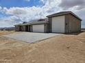 Home with a tile roof and stone accents sitting on a large lot with a brick driveway at 24183 N 196Th Ln, Surprise, AZ 85387