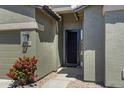 Inviting front entrance with a secure door and lush landscaping at 30031 N Little Leaf Dr, San Tan Valley, AZ 85143