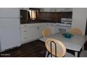 Clean kitchen with white appliances and a dining area at 303 S Recker Rd # 247, Mesa, AZ 85206