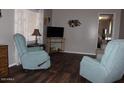 Cozy living room featuring wood-look floors and comfortable recliners at 303 S Recker Rd # 247, Mesa, AZ 85206