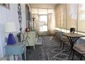 Inviting sun room with vintage furniture and light-filtering curtains at 303 S Recker Rd # 247, Mesa, AZ 85206