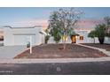 Inviting home featuring a modern exterior, well-maintained landscaping, and ample parking space at 3043 E Hartford Ave, Phoenix, AZ 85032