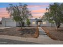 Charming single-story home with stucco exterior, desert landscaping, and a welcoming entrance at 3043 E Hartford Ave, Phoenix, AZ 85032