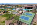 Aerial view of the community featuring a pool, playground, pickleball court, lake, and picnic area at 35175 W Marin Ave, Maricopa, AZ 85138