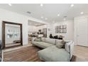Open-concept living area with a modern sofa, stylish decor, and seamless flow to the kitchen at 4077 S Sabrina Dr # 30, Chandler, AZ 85248
