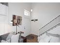 Cozy living room featuring a staircase, high ceilings, and a modern Buddha painting at 4114 E Union Hills Dr # 1088, Phoenix, AZ 85050