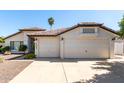 Charming home featuring a well-maintained lawn, two-car garage, and a warm, inviting facade at 4335 E Enrose St, Mesa, AZ 85205
