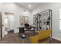 Bright office featuring a dark desk and black shelving, offering a stylish work-from-home space at 4335 E Enrose St, Mesa, AZ 85205