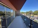 A balcony offers views of the tree-lined street with multiple cars parked along the curb at 4750 N Central Ave # R3, Phoenix, AZ 85012