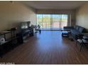 Spacious living room with hardwood floors, comfortable seating, and sliding glass doors to a balcony at 4750 N Central Ave # R3, Phoenix, AZ 85012
