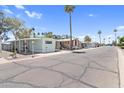Wide street view showing several well-maintained homes, mature trees, and desert landscaping at 535 S Alma School Rd # 17, Mesa, AZ 85210