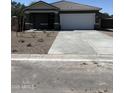 Inviting single-story home featuring a spacious driveway and meticulously xeriscaped front yard, ideal for low-maintenance living at 5781 E Iris Dr, Florence, AZ 85132