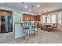Charming kitchen with stainless steel appliances, light wood cabinets, and eat-in dining area at 6027 N 132Nd Dr, Litchfield Park, AZ 85340