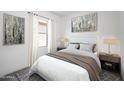 Inviting bedroom featuring a comfortable queen-sized bed, soft lighting, and modern decor at 6057 E Artemis Dr, Florence, AZ 85132