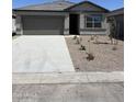 Single-story home featuring a two-car garage and low-maintenance landscaping at 6064 E Artemis Dr, Florence, AZ 85132
