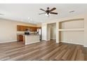 Spacious open-concept living room featuring wood floors and view of the kitchen at 6103 S 54Th Ave, Laveen, AZ 85339