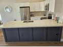 Bright kitchen with stainless steel appliances, quartz countertop island and white shaker cabinets at 6873 S Lake Forest Ct, Chandler, AZ 85249