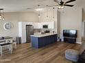 Open-concept kitchen featuring modern appliances, white cabinets, and a stylish kitchen island at 6873 S Lake Forest Ct, Chandler, AZ 85249