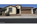 Charming single-story home featuring desert landscaping, a brown garage door, and a tile roof at 7046 N 84Th Dr, Glendale, AZ 85305