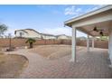 Spacious backyard with a brick-paved patio, perfect for entertaining, and surrounded by a block fence at 7309 W Getty Dr, Phoenix, AZ 85043