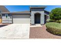 Charming home with a well-maintained front yard, two car garage and drought-tolerant landscaping at 7824 S 33Rd Ln, Laveen, AZ 85339