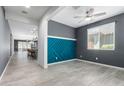 Modern living room with tile flooring, decorative accent wall and open concept design at 7824 S 33Rd Ln, Laveen, AZ 85339