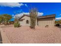 Desert landscaping complements this single-story home with neutral tones at 8248 E Emelita Ave, Mesa, AZ 85208