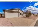 Well-maintained single-story home featuring a two-car garage and desert landscaping at 8248 E Emelita Ave, Mesa, AZ 85208