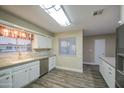 Bright kitchen with stainless steel appliances, white cabinets, and a stylish backsplash, perfect for modern living at 10620 W Clair Dr, Sun City, AZ 85351