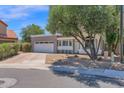 Charming two-story home with a well-maintained yard and a two-car garage on a sunny day at 1130 S Surfside Dr, Gilbert, AZ 85233