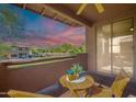Private balcony features peaceful desert views, cozy seating, and a beautiful sunset at 11500 E Cochise Dr # 2088, Scottsdale, AZ 85259