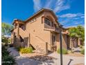 Charming two-story condo featuring well-maintained landscaping, stone accents, and private entrances at 11500 E Cochise Dr # 2088, Scottsdale, AZ 85259