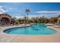 Enjoy resort-style living with this community pool, surrounded by palm trees and lounge chairs at 11500 E Cochise Dr # 2088, Scottsdale, AZ 85259