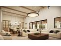 Bright and airy living room with high ceilings, wood beams, a large sectional sofa, and views of the dining and kitchen area at 13202 N 76Th Pl, Scottsdale, AZ 85260