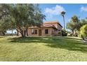 Inviting two-story home with well-manicured lawn and trees, offering a warm, Gathering-friendly appeal at 14401 N Boxwood Ln, Fountain Hills, AZ 85268