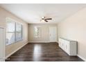 Bright living room with wood floors, a ceiling fan, and natural light perfect for welcoming guests at 14401 N Boxwood Ln, Fountain Hills, AZ 85268