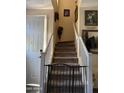 Interior view of a carpeted staircase with white railings and a baby gate at the bottom at 1448 E Mobile Ln, Phoenix, AZ 85040