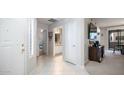 Bright hallway featuring tile flooring, white doors, and easy access to multiple rooms at 15252 N 100Th St # 1134, Scottsdale, AZ 85260
