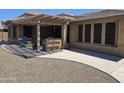 View of backyard patio with outdoor seating and built in grill at 15352 W Ventura St, Surprise, AZ 85379