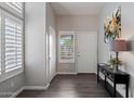 Bright foyer with wood floors, white walls, and natural light from shuttered sidelight window at 16636 S 22Nd St, Phoenix, AZ 85048