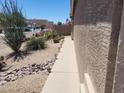 Landscaped side yard featuring decorative rock, desert plants and solar lighting for evening ambiance at 1769 E Jacob St, San Tan Valley, AZ 85140