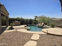 Beautiful backyard with a pool, outdoor kitchen, and plenty of space for entertaining at 18359 W Sweet Acacia Dr, Goodyear, AZ 85338