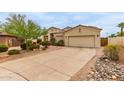 Attractive single-story house with a two-car garage and a long concrete driveway at 18415 W Capistrano Ave, Goodyear, AZ 85338