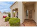 Cozy front porch with seating, beautiful landscaping, and a decorative security door at 18415 W Capistrano Ave, Goodyear, AZ 85338